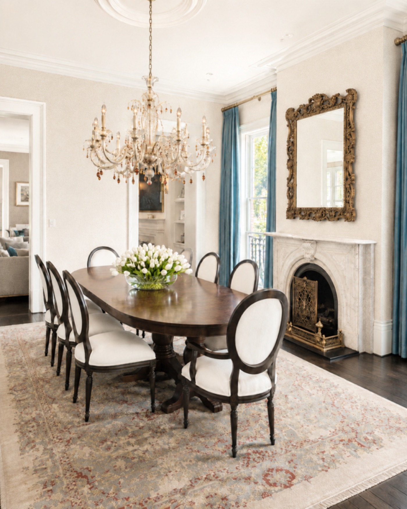 A historic Savannah dining room designed by Bluff and Bay, oval-back chairs and a marble fireplace