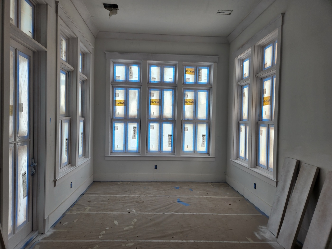 A room under construction in Kary's Bluffton home showing the extra height of 12-foot ceilings and a wall of windows