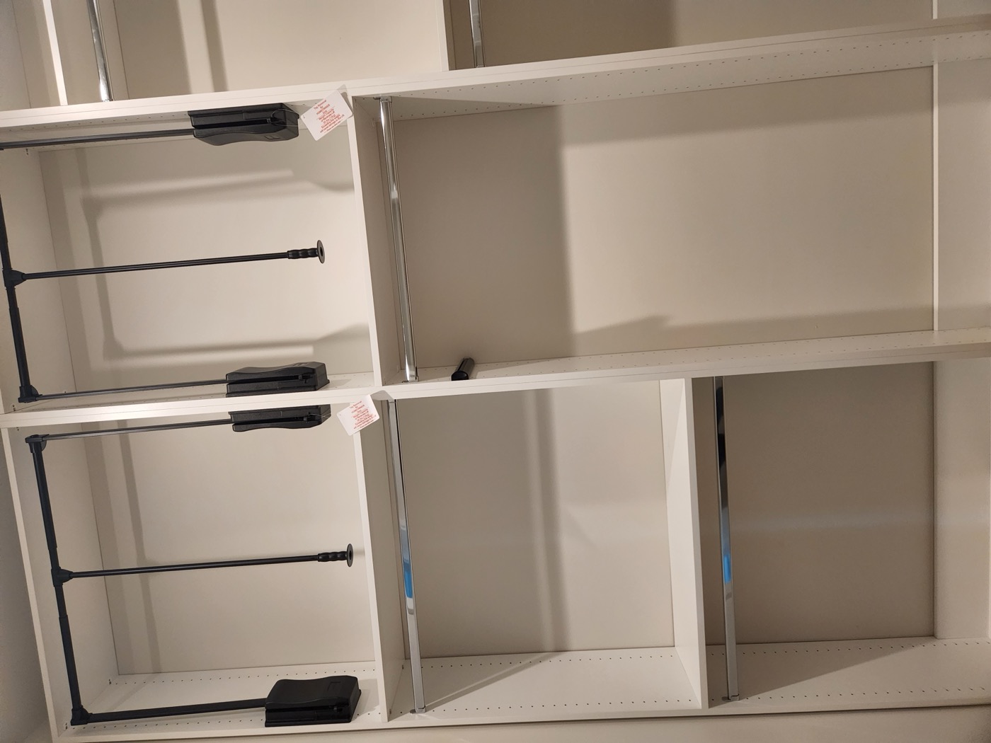 Custom closet storage in Kary's Bluffton home with multiple levels of hanging rods, drawers and shelving
