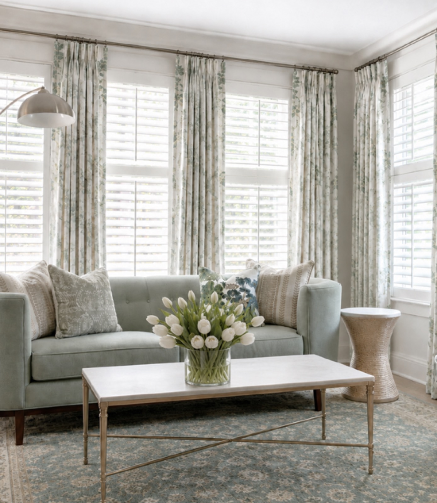 Living room with plantation shutters and custom floor to ceiling drapery panels